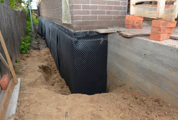 SJ Waterproofing Pros technician performing targeted Wet Basement Repair assessment in Pinson, AL